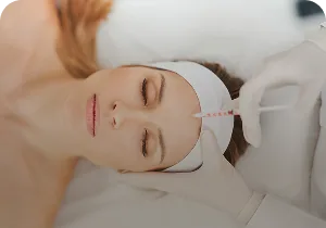 Forehead injection on a woman wearing a headband – botulinum toxin