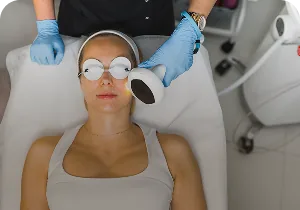 Woman wearing protective goggles during an IPL treatment – Lumecca by InMode